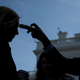 People entering the White House have their temperature taken.